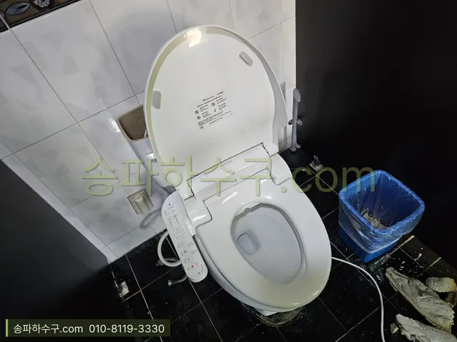 비데 일체형 변기가 설치된 검정 타일 화장실
